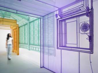 A figure walking through a colourful architectural tunnel.